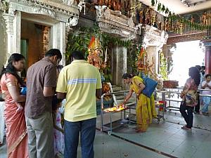 寺院の広間で祈りを捧げる信者たち