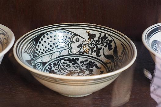 陳列棚にはスワンカローク焼のような陶器。デザインは沖縄のやちむんに似ている。