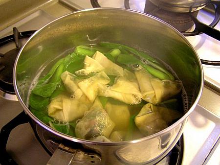 4. 丸鶏から取ったスープを沸かし、残りのちんげん菜を入れたら、わんたんをひとつづつ入れる 

