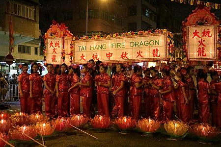 可愛らしい女の子たちは伝統的な衣装に身をつつみ、蓮の花のランタンを持って火龍を迎えます。