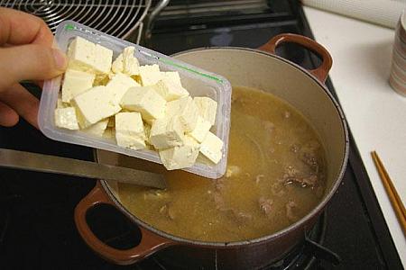 11. 豆腐を加えひと煮立ちさせる。