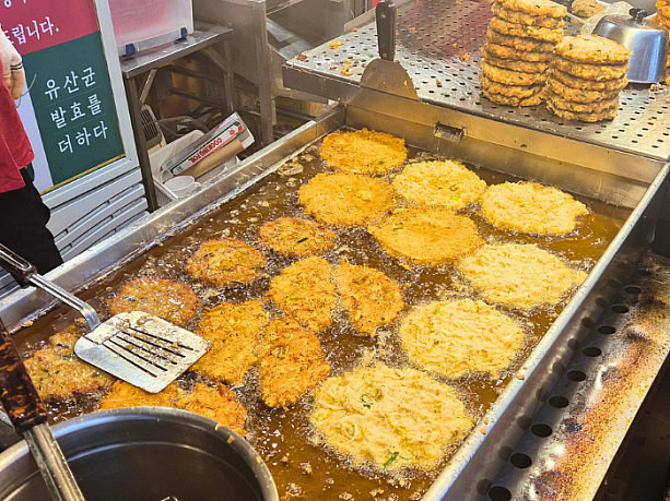こちらも広蔵市場の名物の１つ、ビンデトッ（緑豆チヂミ）。お店の前で調理しています。おいしそう。
